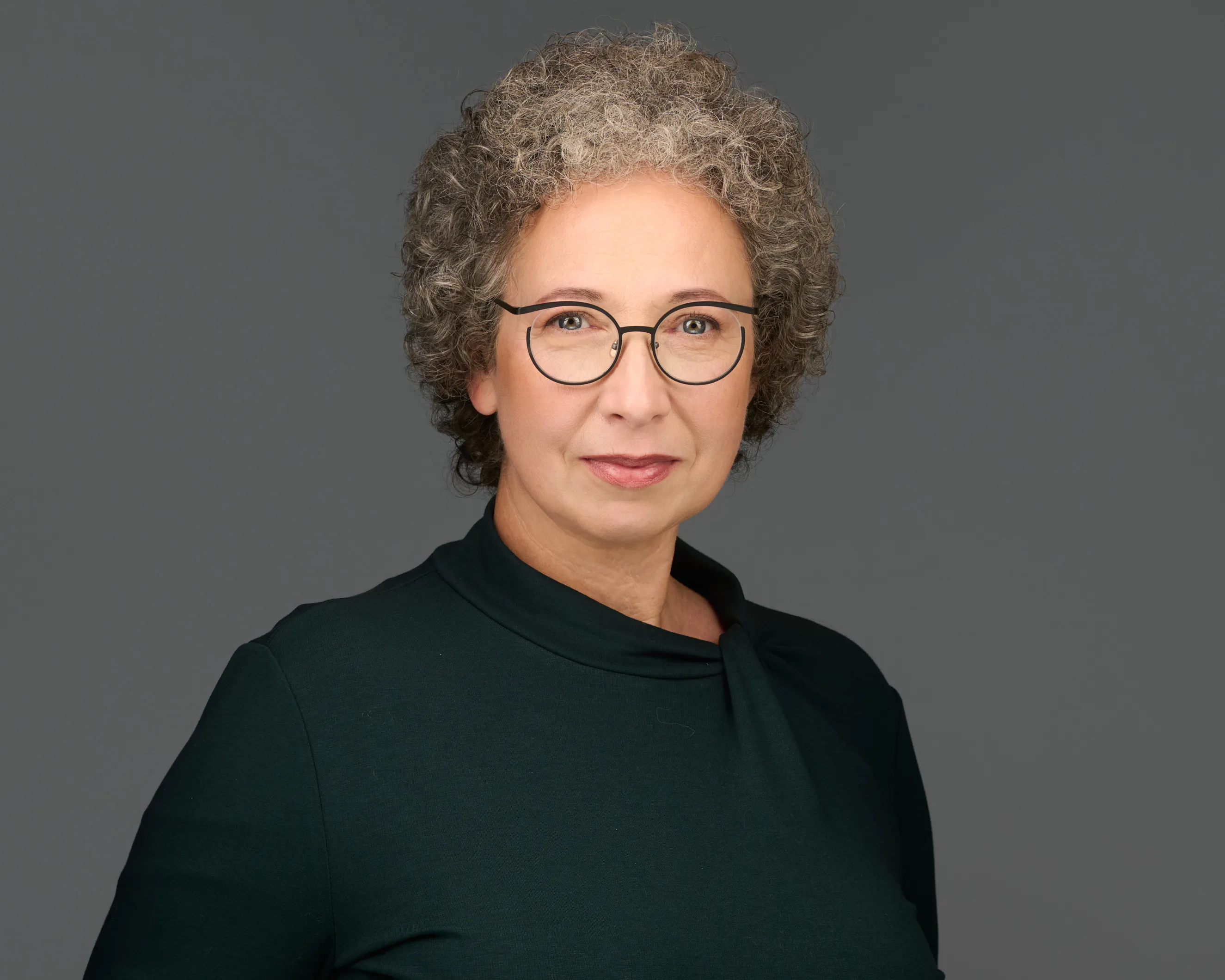 בעלת עסק בסטודיו. צילום עסקים בחיוך נגיש ואנרגיה מקצועית תחת תאורה מוקפדת. צילומי תדמית המיועדים לפרופיל הלינקדאין.