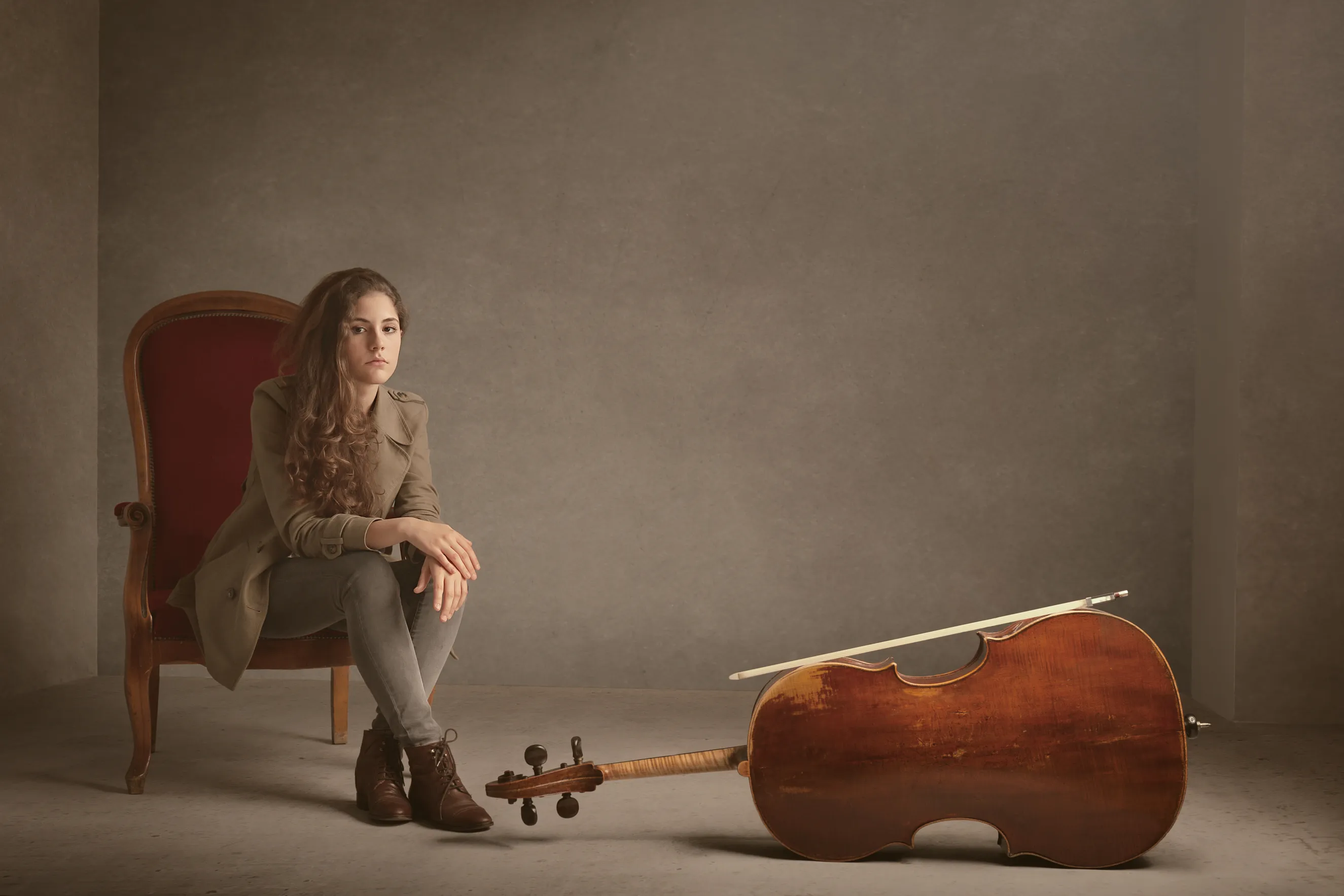 פורטרט מוזיקאי המיועד לפרומואים ויחסי ציבור של צ'לנית מגרמניה בסטודיו עם עיבוד צבע אמנותי, באווירה דינמית המייצגת את האנרגיה שעל הבמה.