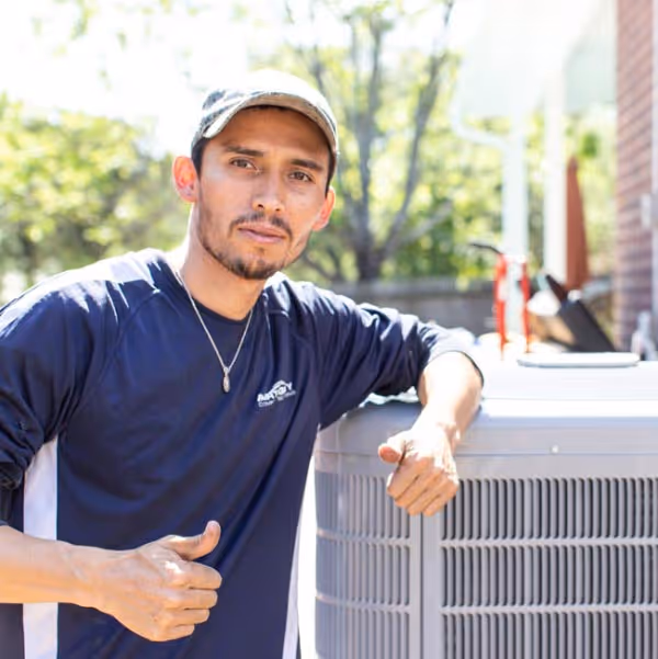 HVAC technician performing a heating repair on a gas furnace in San Antonio.