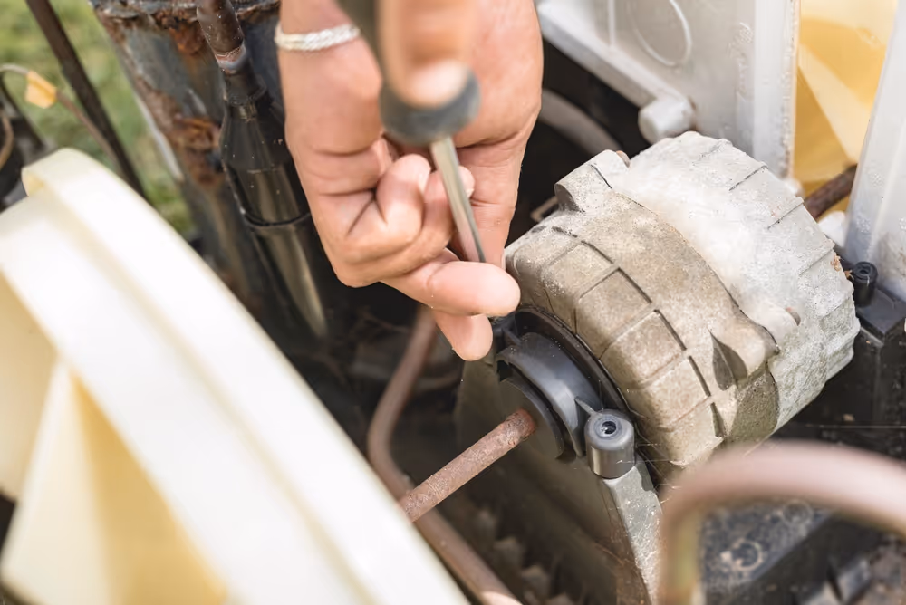 A new blower motor being installed into a residential hvac unit.