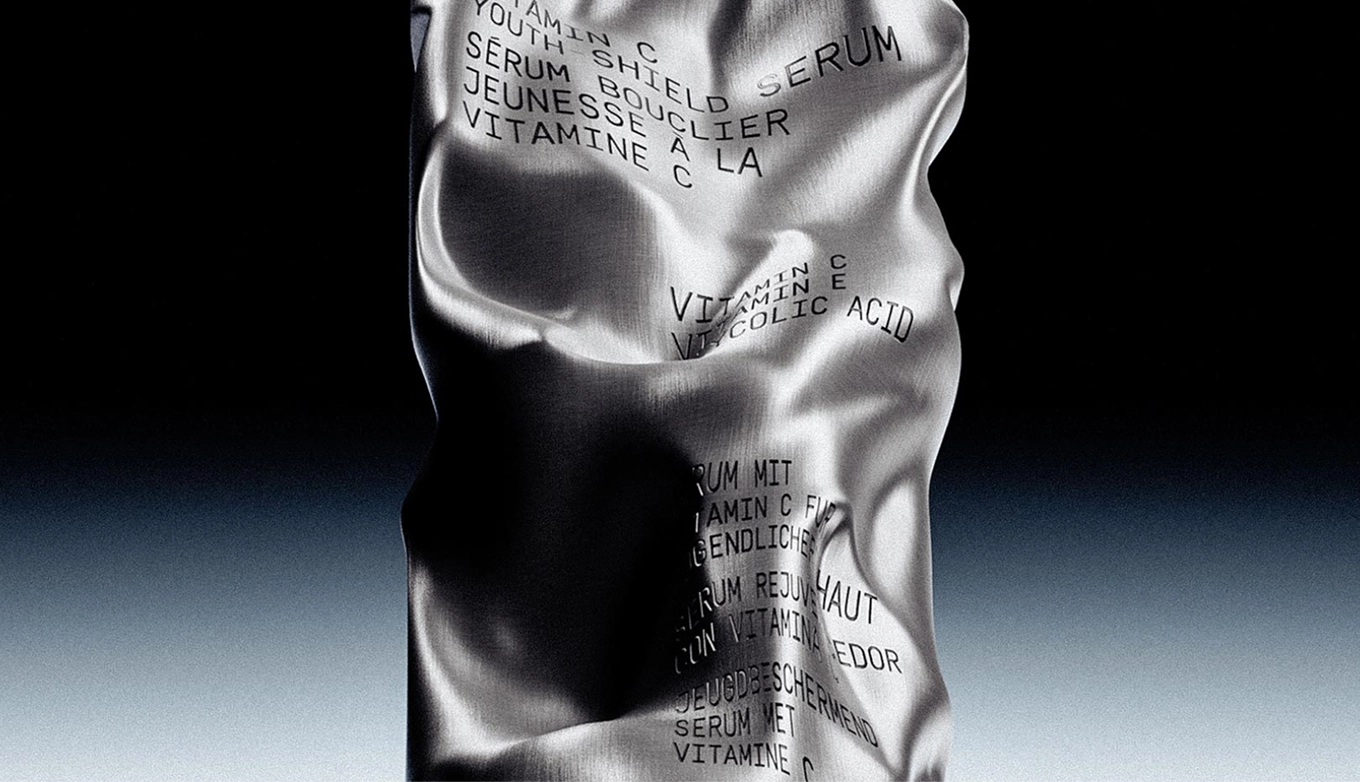 A silver sculpture featuring engraved words, reflecting artistic expression and thoughtful design.