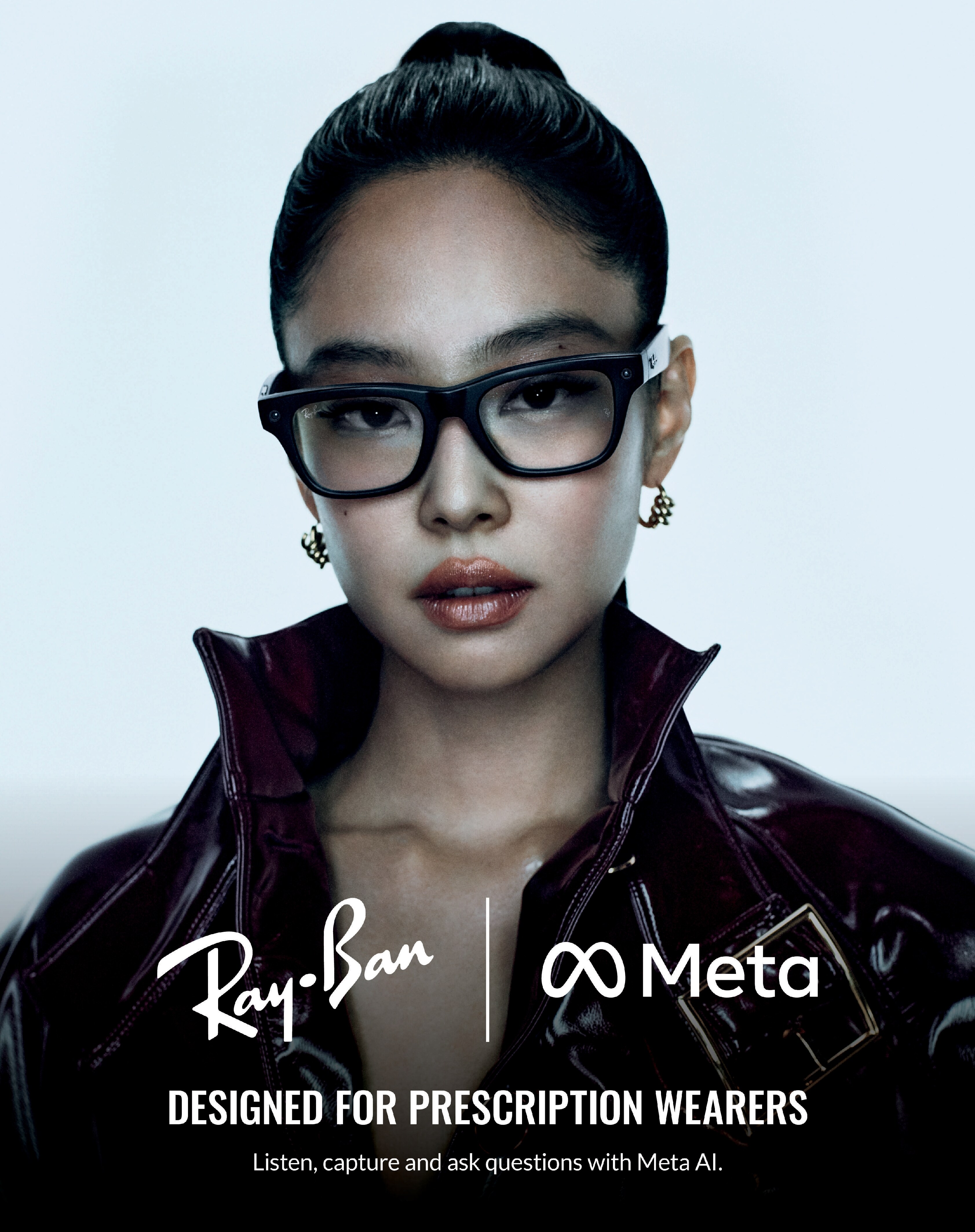 Close-up of a woman wearing fashionable Ray-Ban prescription glasses and gold earrings, dressed in a dark glossy jacket, with Ray-Ban and Meta logos above text reading 'Designed for prescription wearers' and 'Listen, capture and ask questions with Meta AI.'
