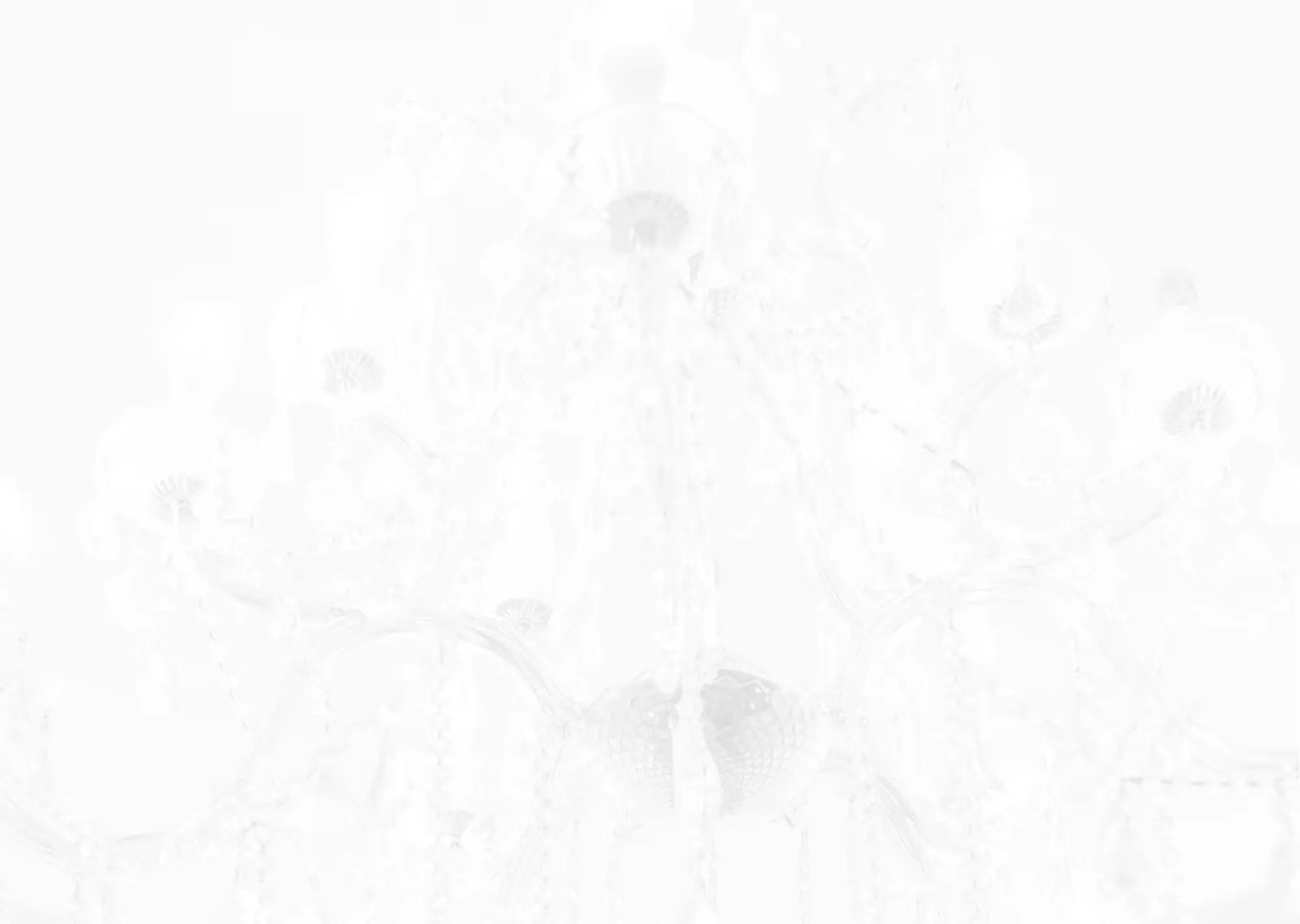 A white chandelier hanging from a ceiling.