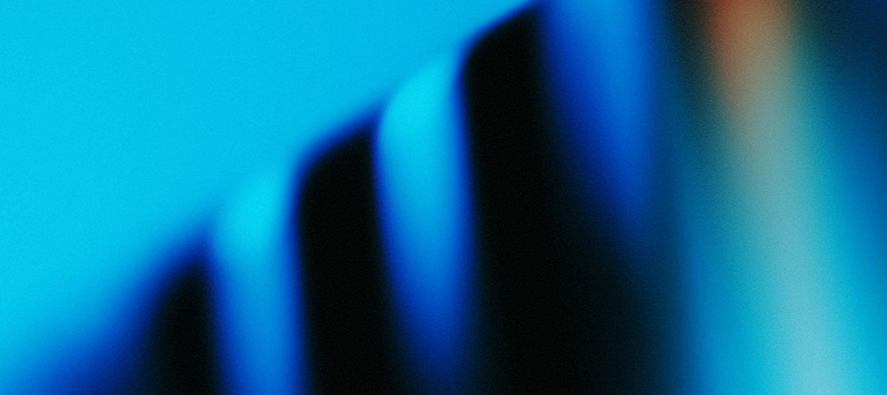 Abstract image featuring blurred vertical shapes in blue and black shades against a bright blue background.