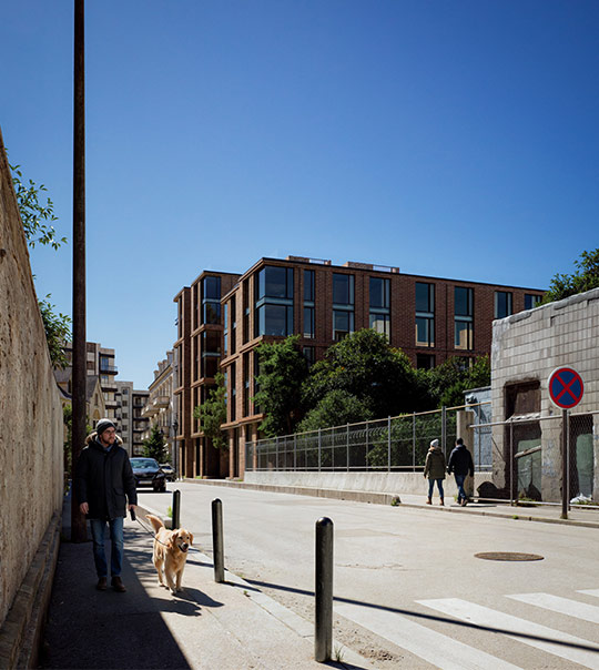 Close-up of a person wearing black winter gear, including a beanie and goggles with snowflakes on the face and clothing.