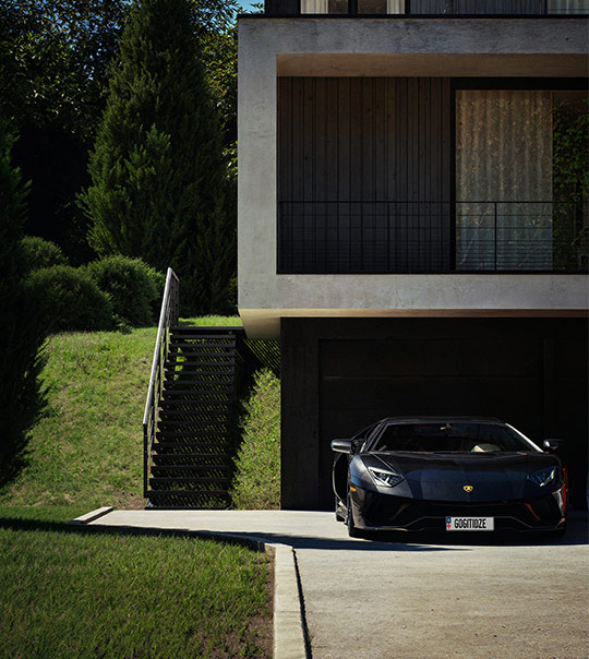 Corner view of a beige building with large display windows showing a white coat on a mannequin and colorful clothes inside a store.