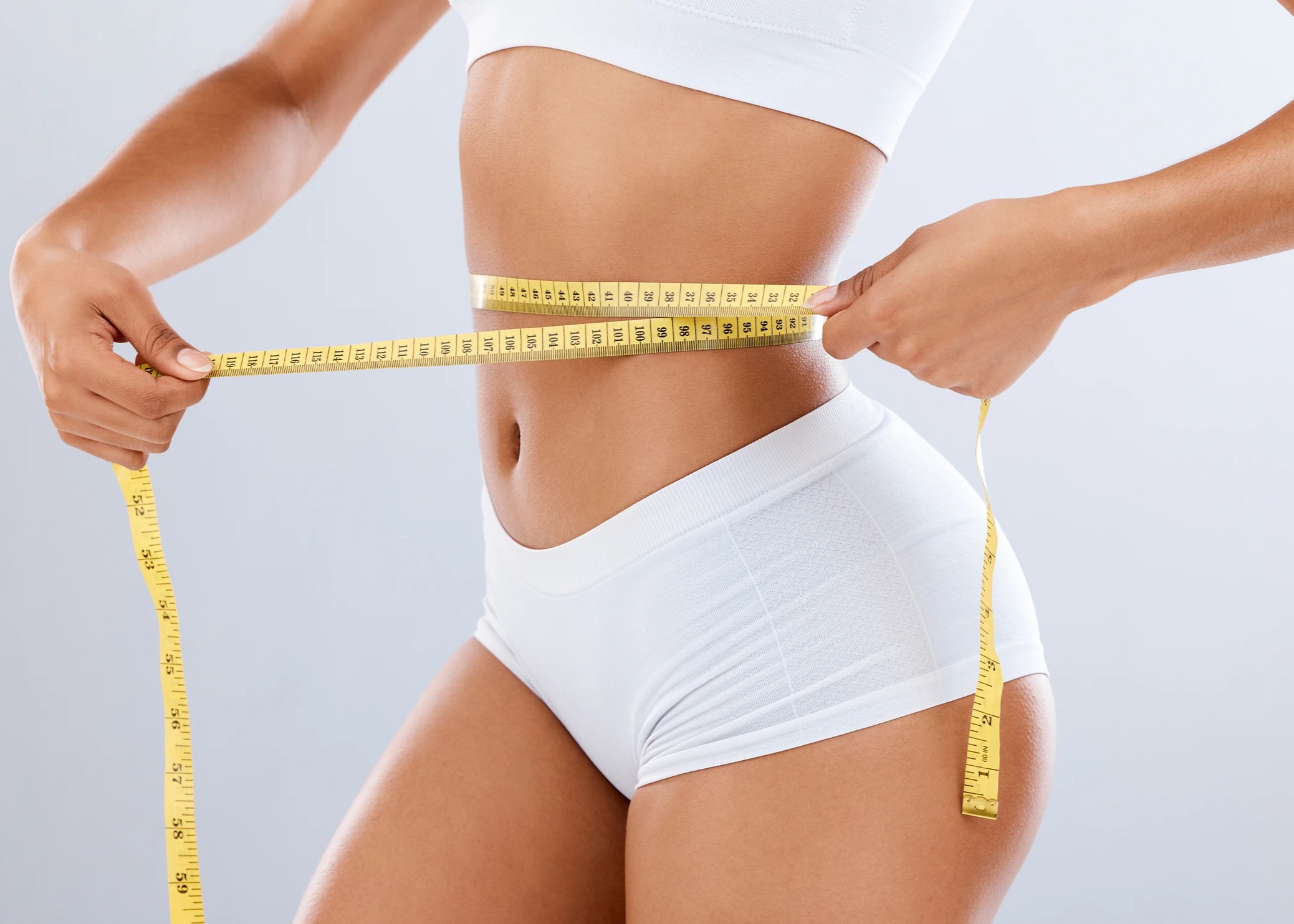 A woman measuring her waist