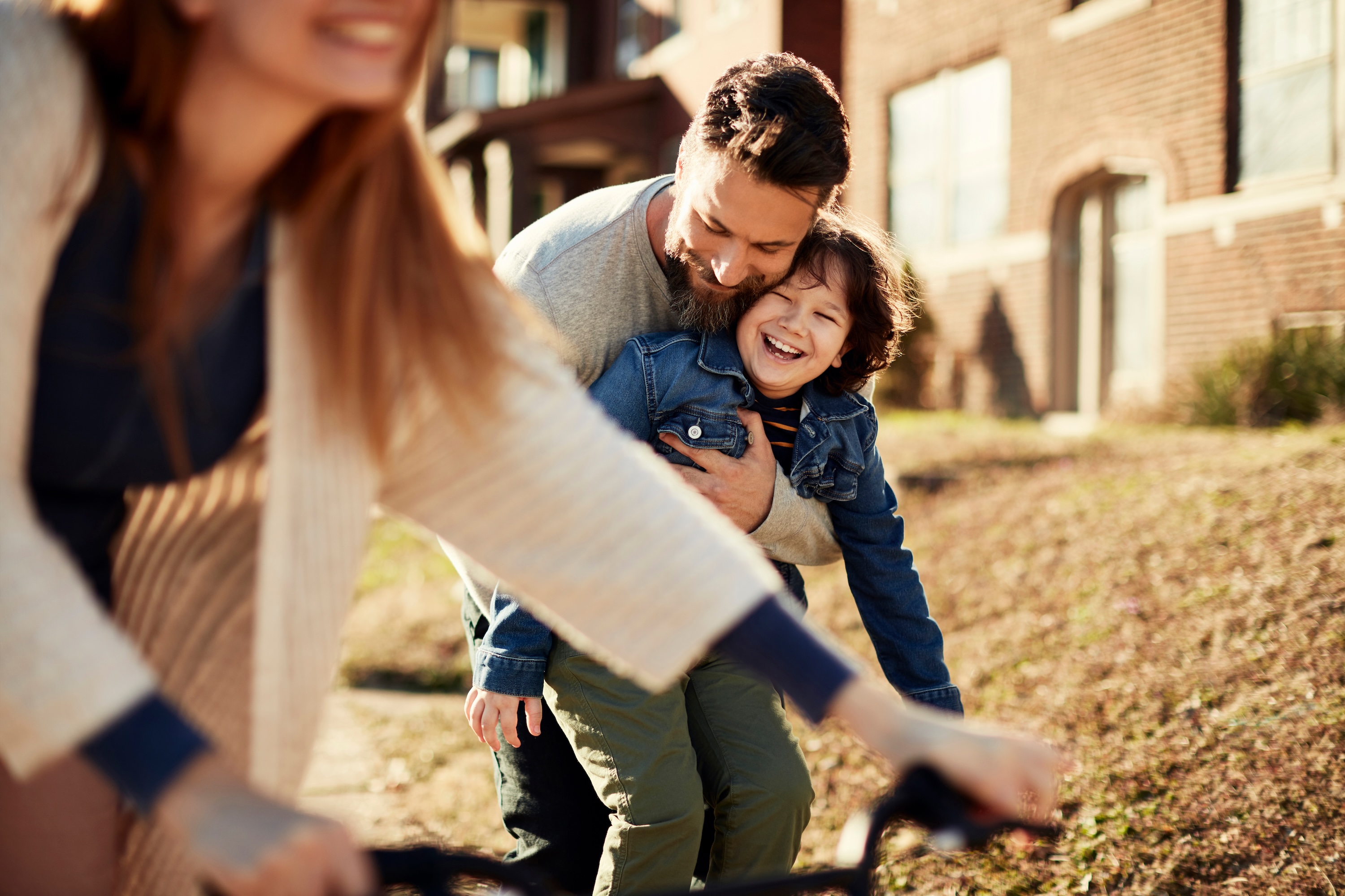 Adult and child laughing together outdoors near Adora at Rosehill, Tomball