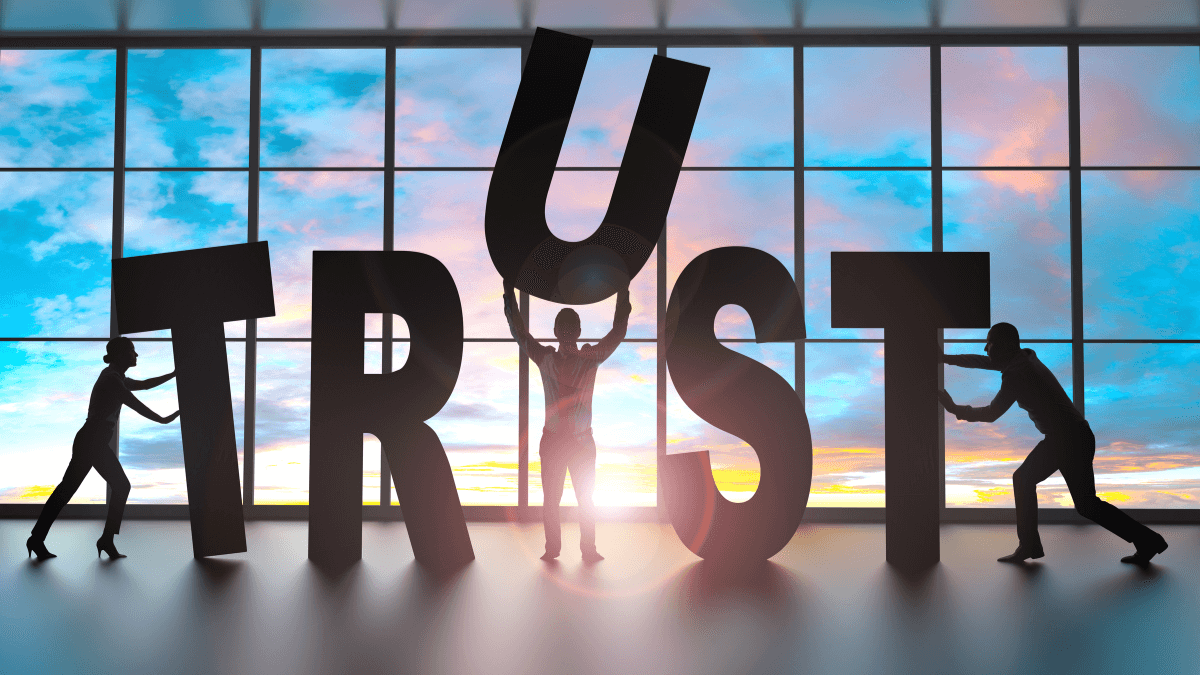 People forming the word Trust letter by letter