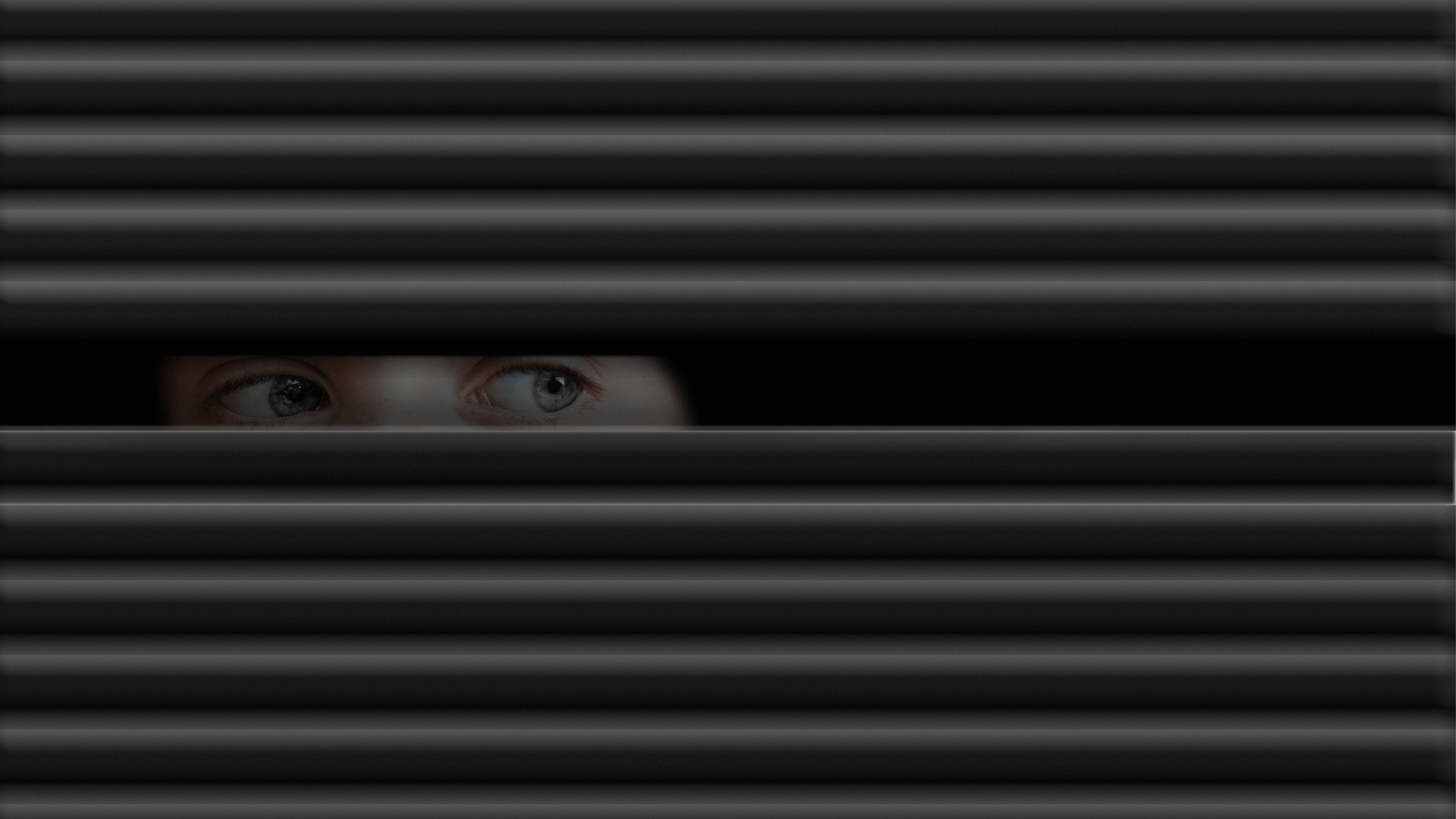 A woman peeking through a black window