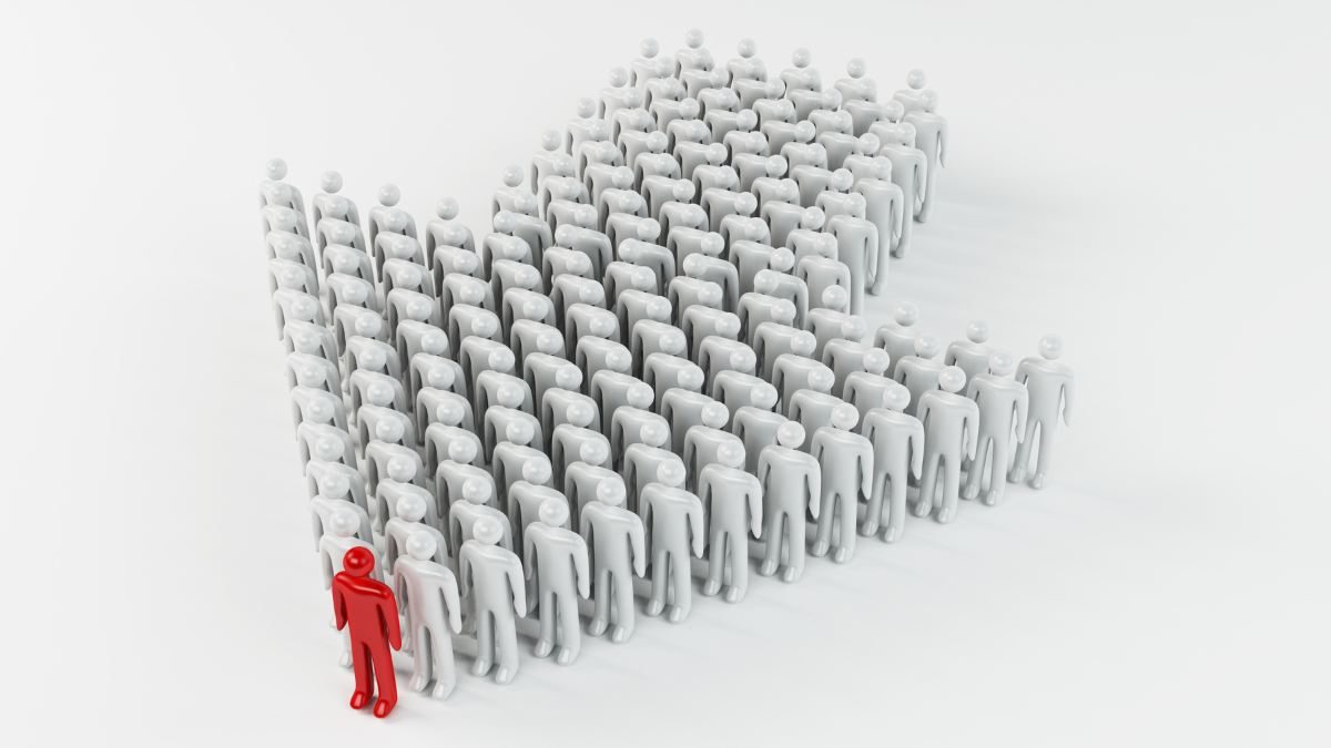 An arrow shape made by multiple people in line with the tip marked in red illustrating leadership