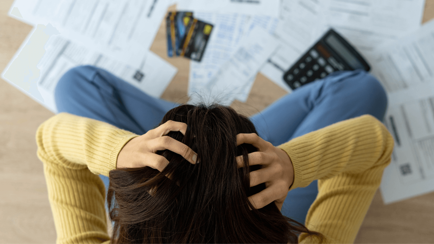 A woman scratching her head with two hands showing that she's having a problem