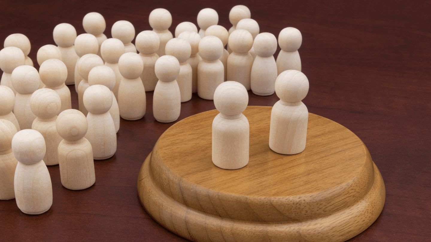 A wooden-made used to illustrate people on a crowd while two are on a platform
