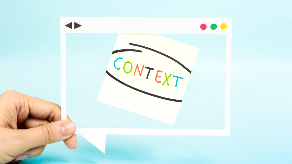 A person holding a message bubble that displays a notes with CONTEXT encircled
