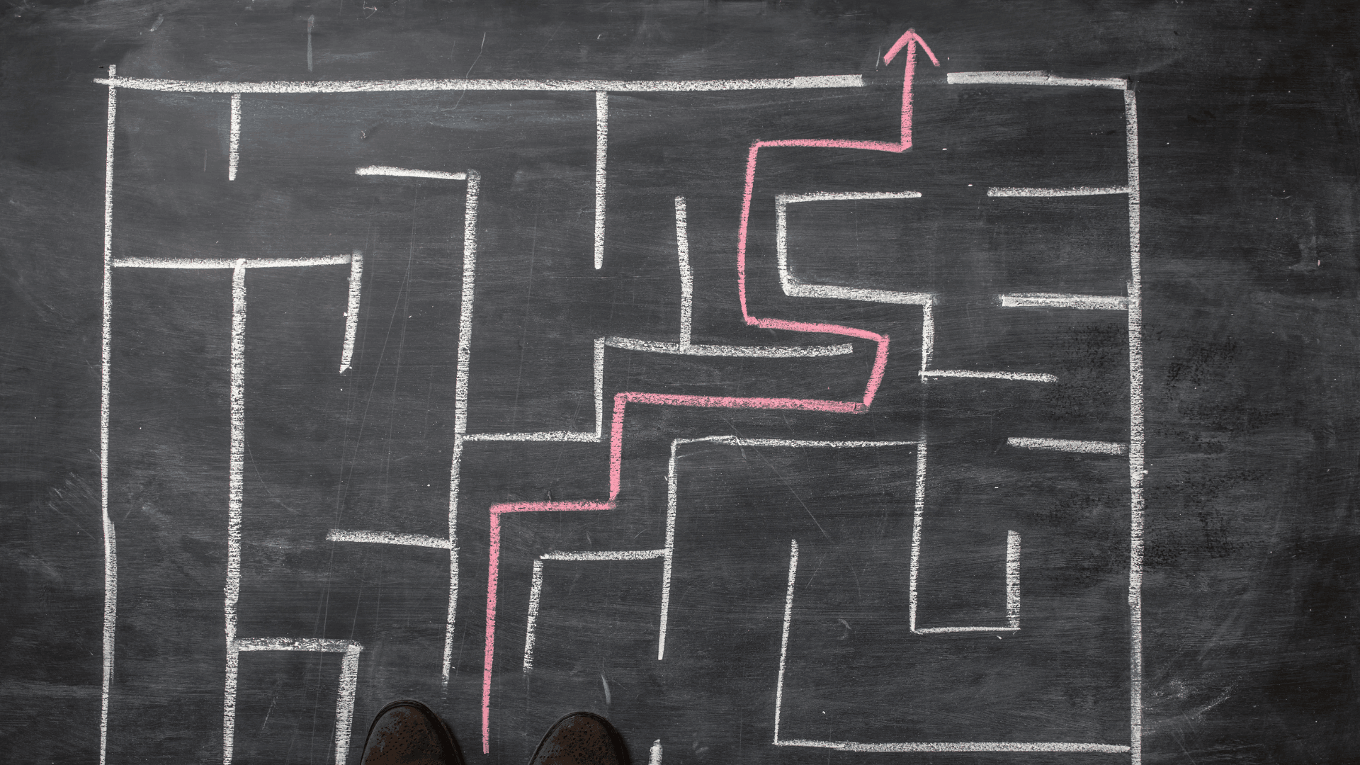 A chalk-drawn maze with directions