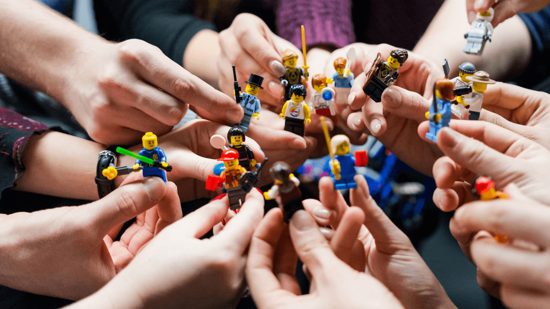 A group of people playing a Lego toy