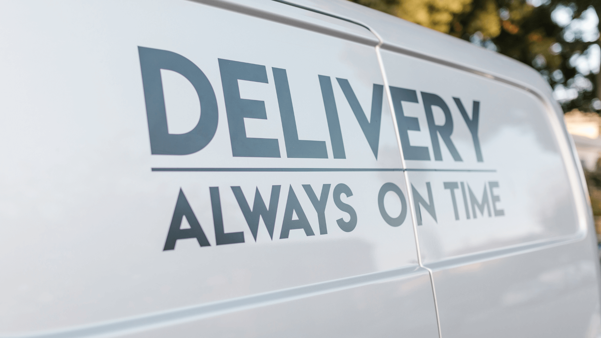 An image of a van's door with the text "Delivery Always On Time"