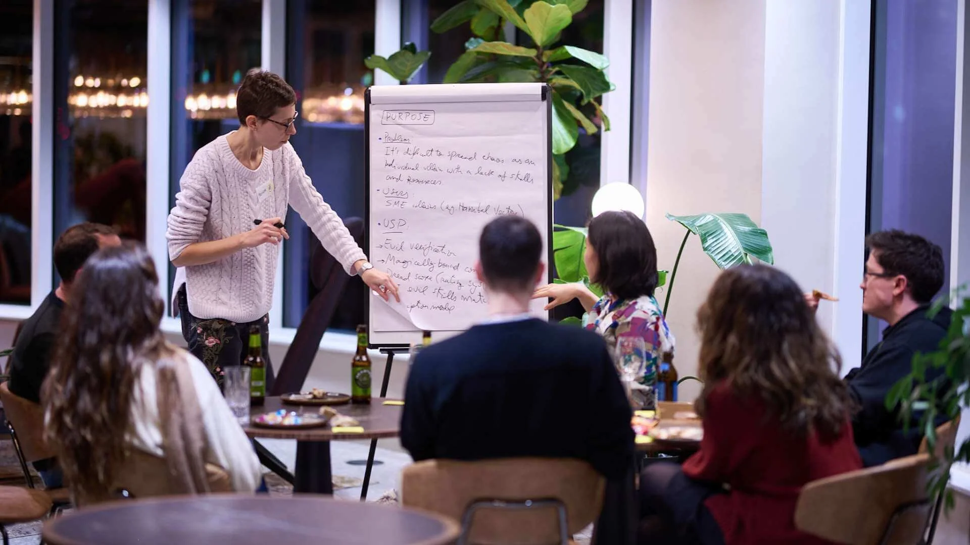 A group of people doing a discussion using a white paper on a flip chart stand