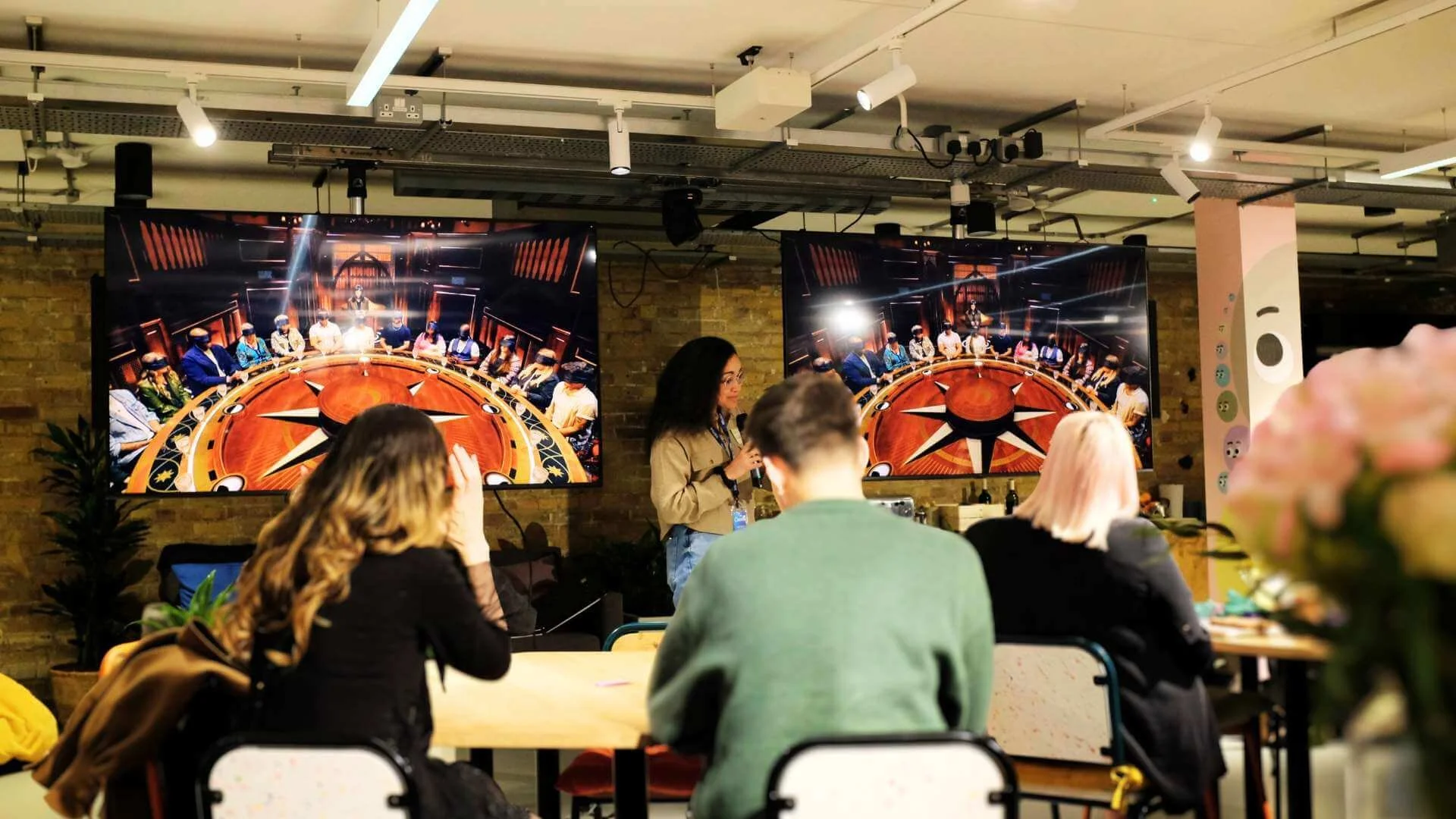 A person doing a discussion while the crowd is listening