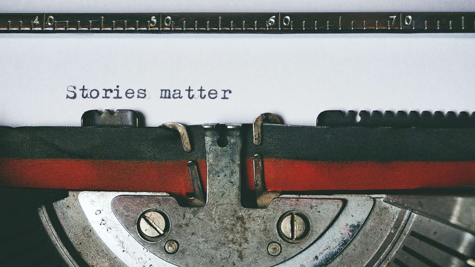 Text containing "Stories matter" written through a typewriter