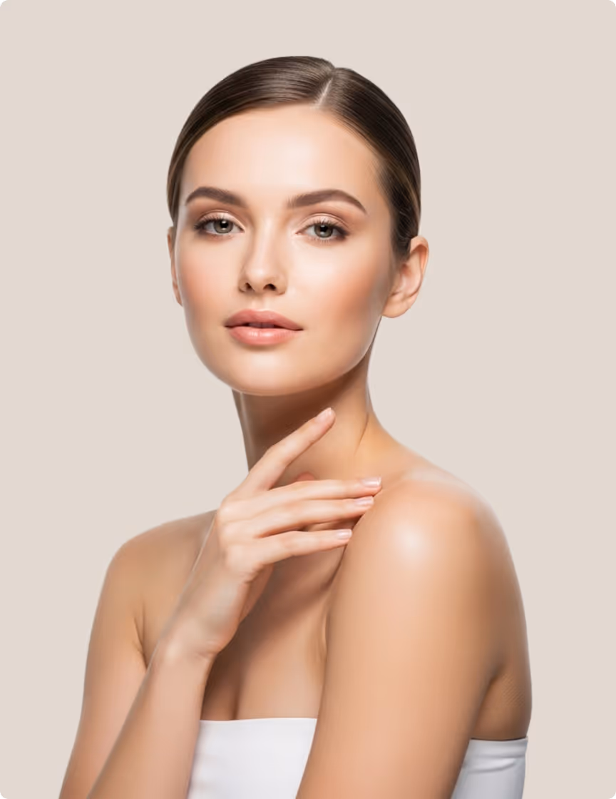 Portrait of a woman with flawless skin gently touching her neck against a beige background.