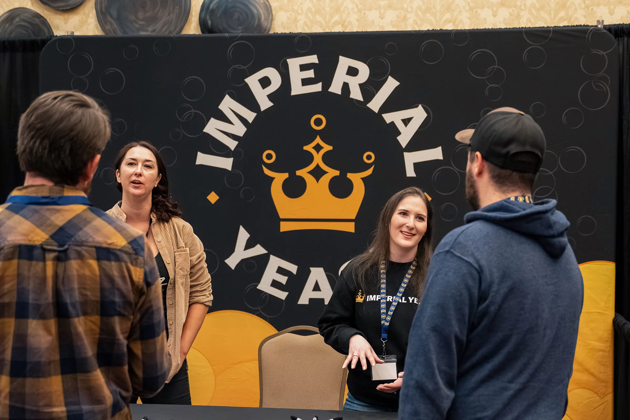 Attendees networking near Imperial Yeast booth at summit
