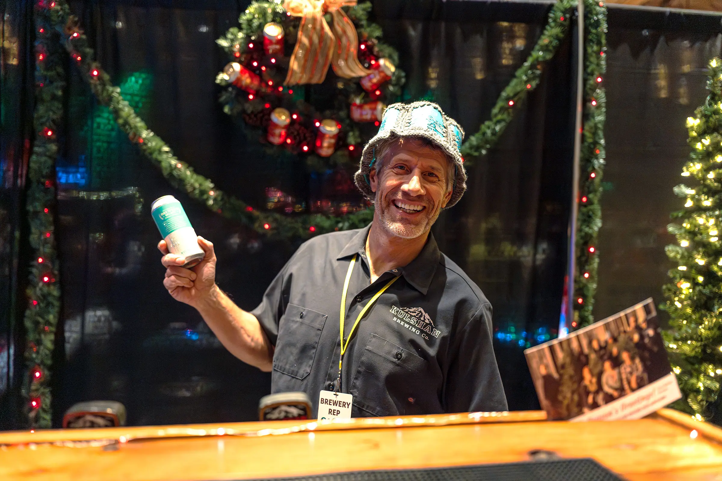 Brewery representative posing and smiling with a can of beer at Winter Beer Fest 2025