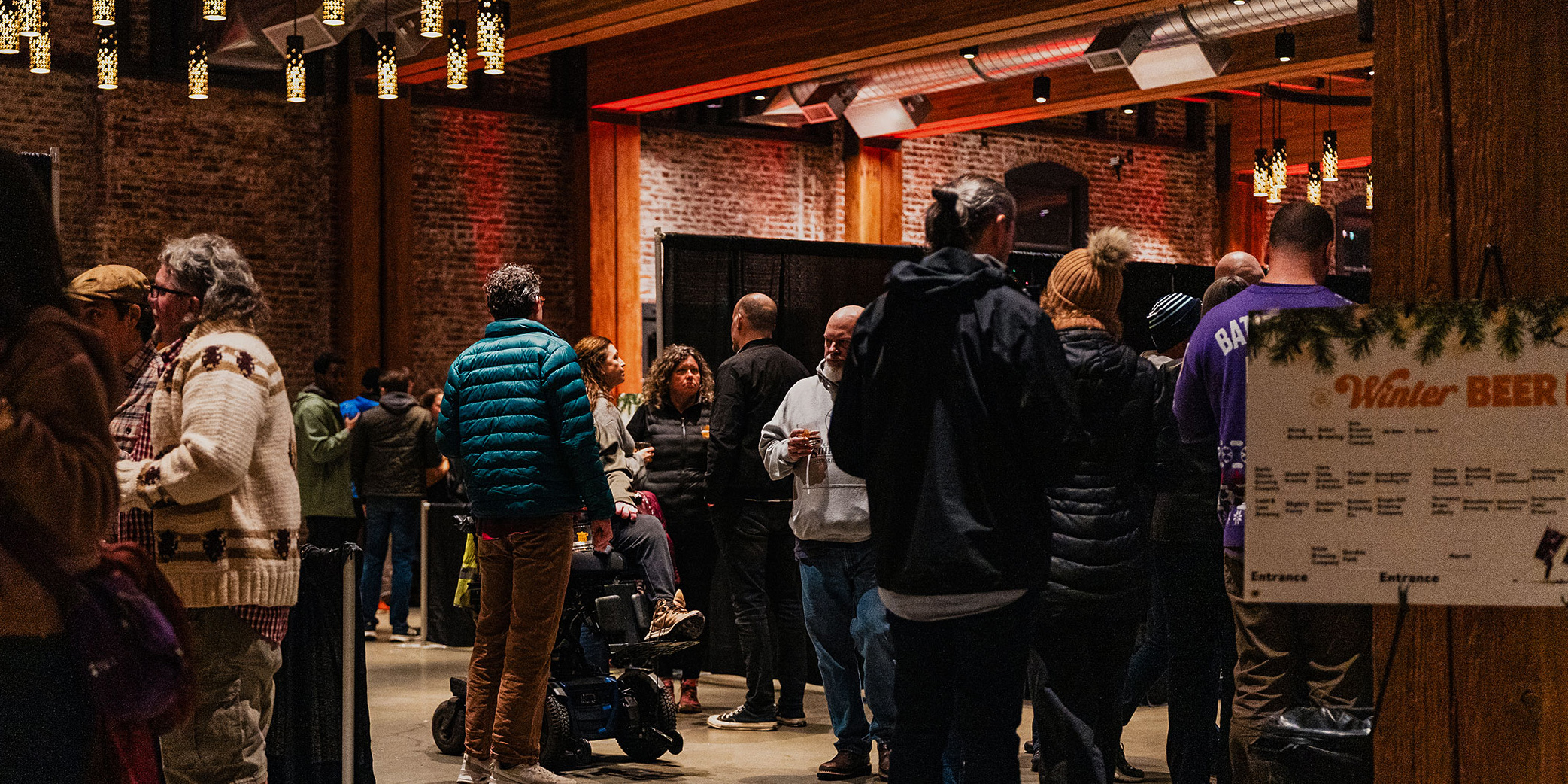 Crowded interior of Washington Winter Beer Fest 2025 with attendees gathering inside a brewery event hall