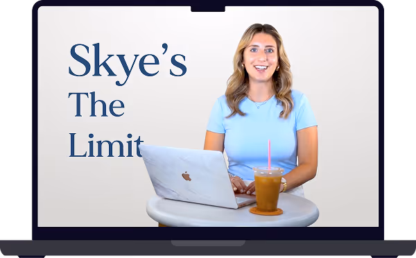 A woman in a light blue shirt smiling while using a laptop on a small round table with an iced drink next to her and the text 'Skye’s The Limit' on a light background.