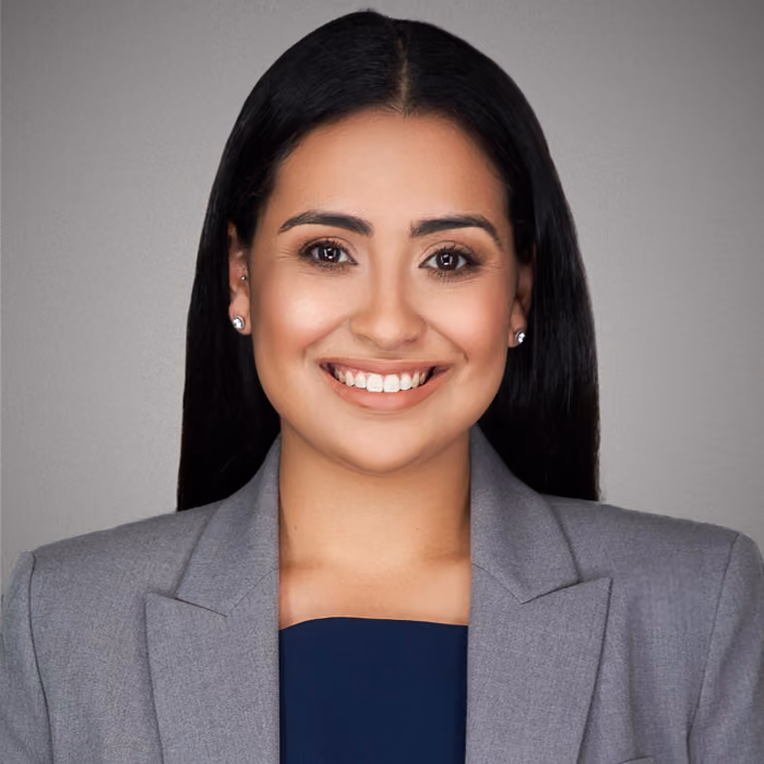 Jessalyn Marrero, headshot smiling in a gray blazer.