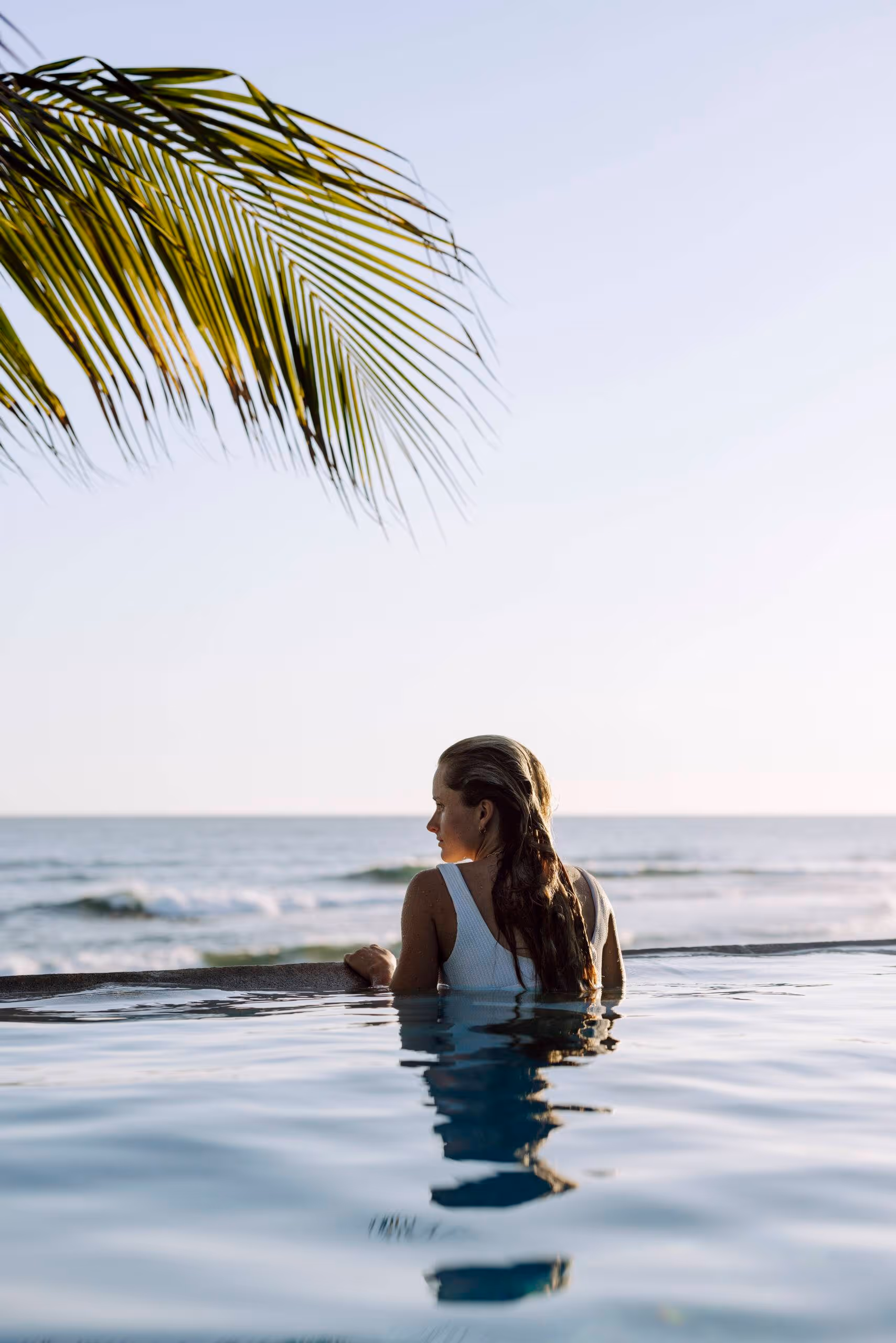 A guest looking at the ocean from the beach