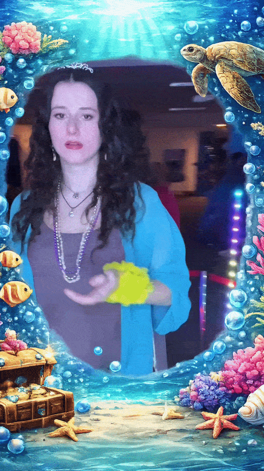 360 photo booth example video with people dancing on a platform. Woman with curly hair appears surrounded by animated underwater sea life and coral frame with bubbles.