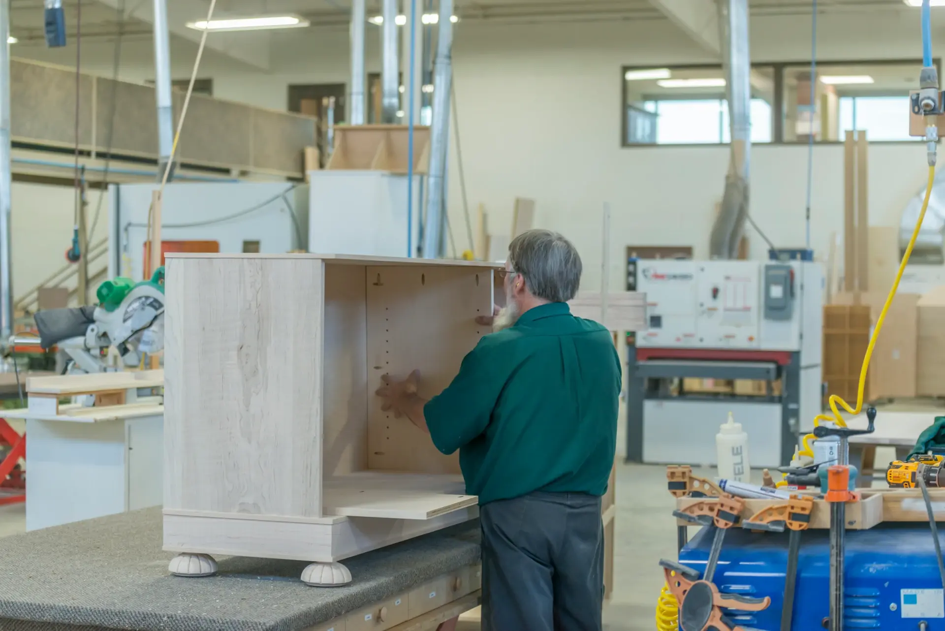 homestead factory worker assembling wood furniture