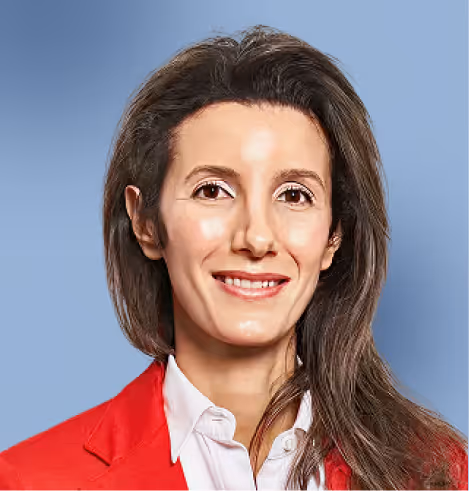 Smiling woman with long brown hair wearing a red blazer and white shirt against a blue background.