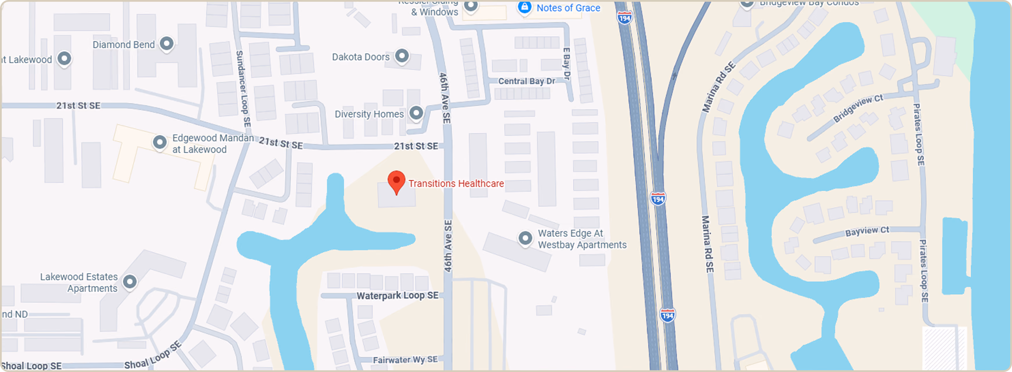 Map highlighting Transitions Healthcare near 46th Ave SE and 21st St SE, surrounded by residential areas and waterways.