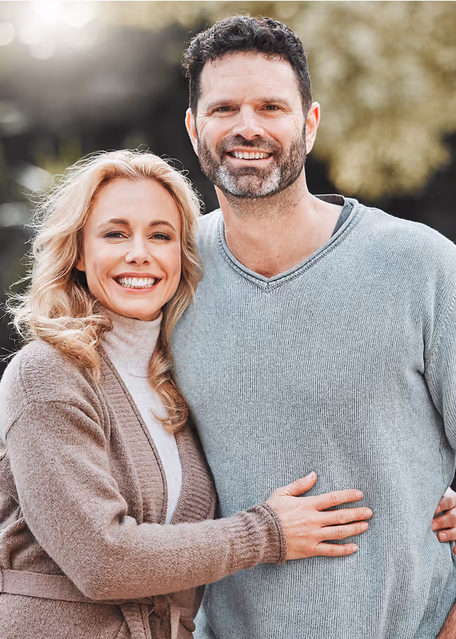 Couple smiling after personalized hormone therapy at Transitions Healthcare