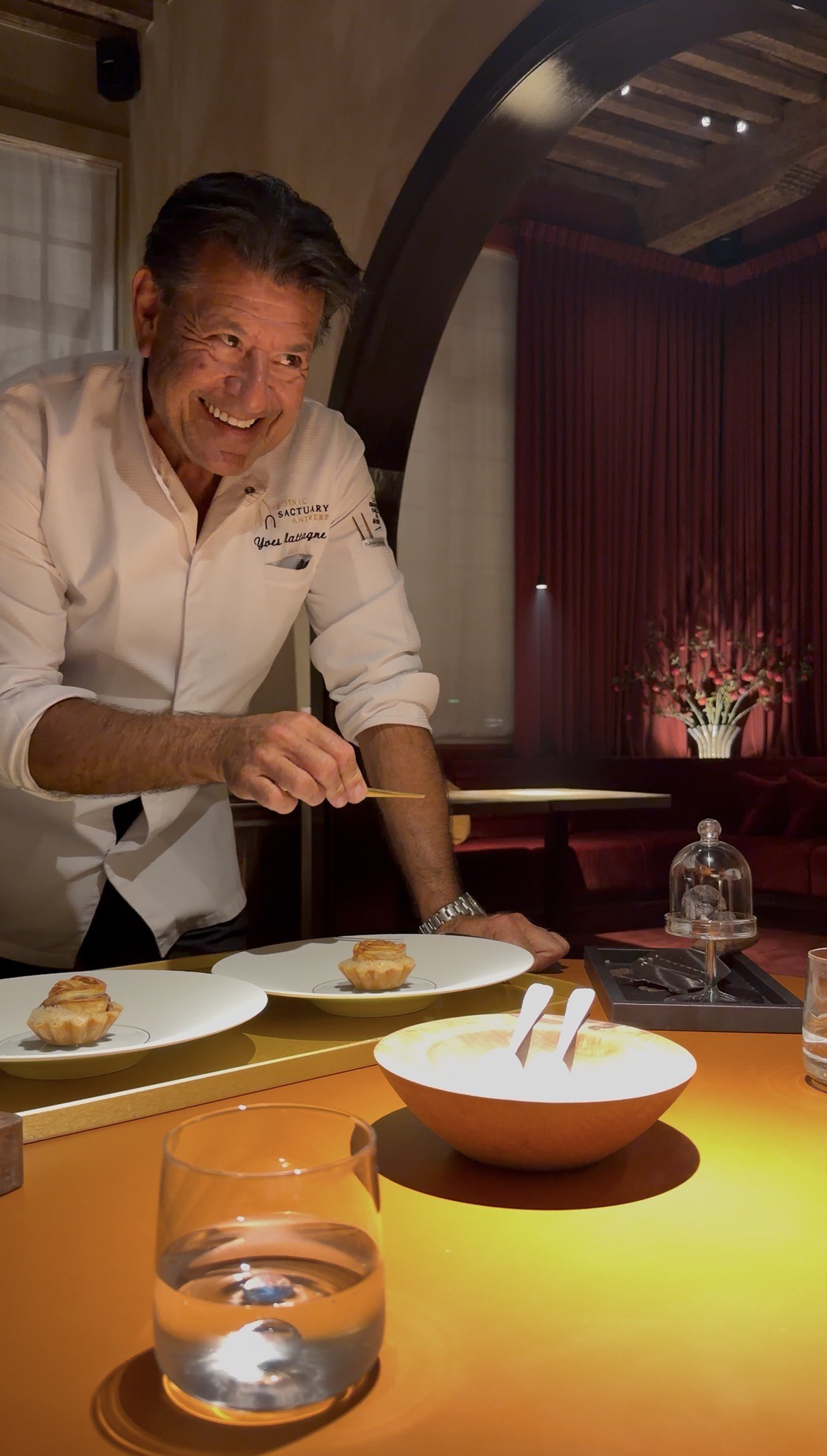 Yves Mattagne finishing a dish at the table
