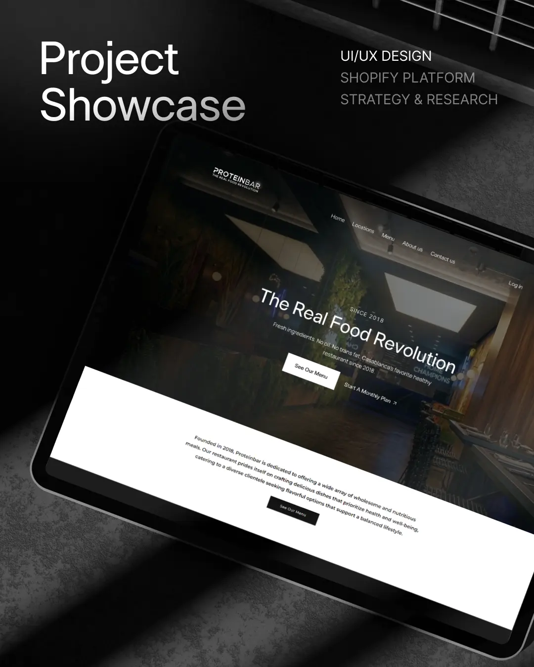 Tablet showing Proteinbar website with slogan The Real Food Revolution on a dark textured surface.