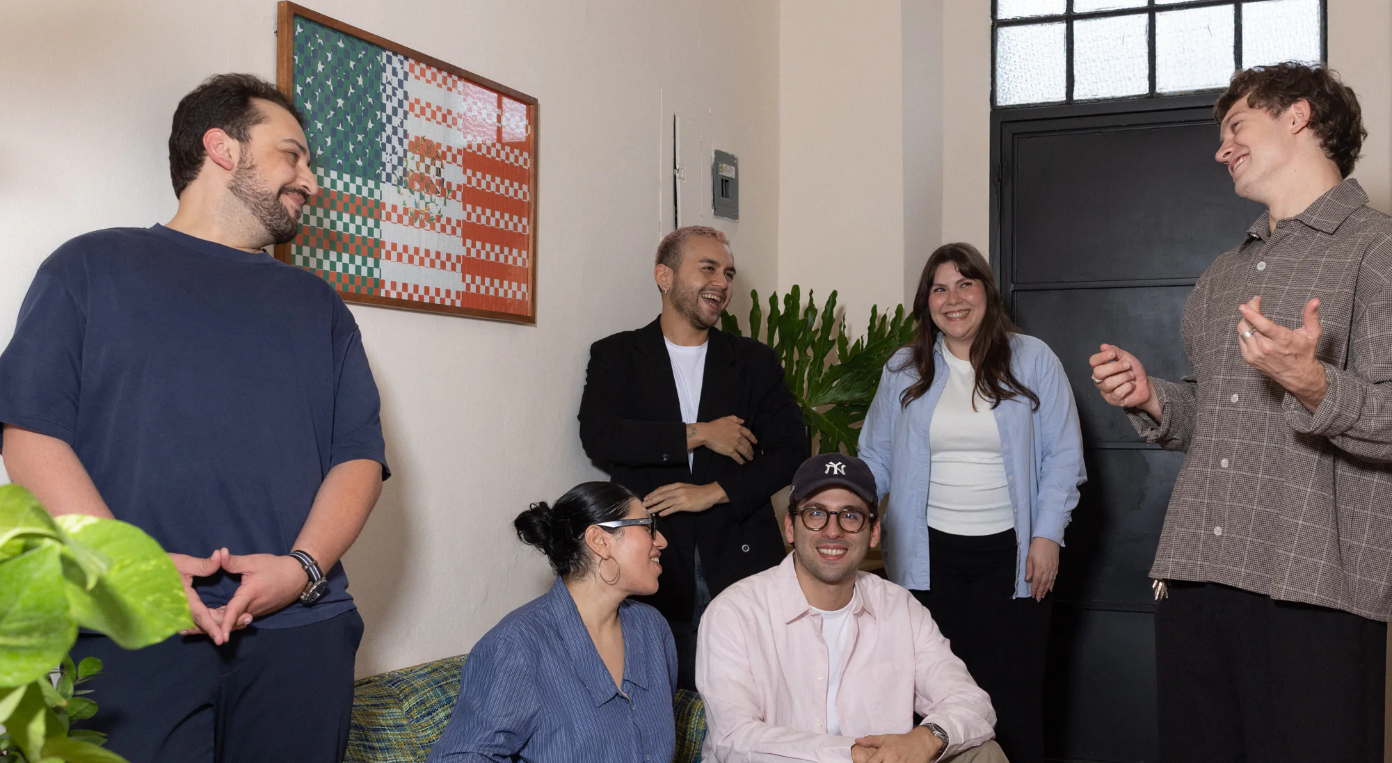 The Calo team seated together on couches in the studio