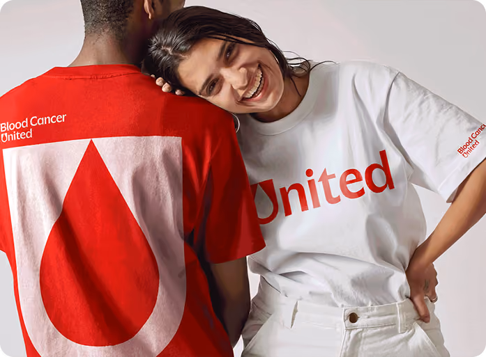 Two people in red and white Blood Cancer United t-shirts