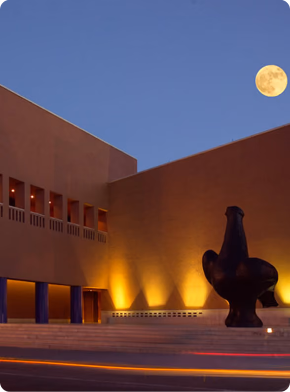 Museum plaza at dusk under the moon