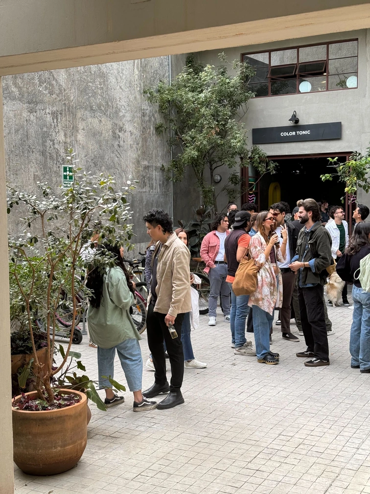Crowd gathered in a gallery courtyard at a Calo artist residency opening