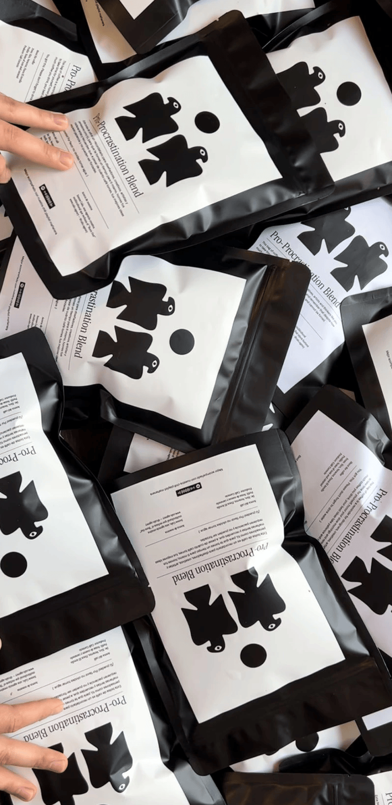 Pile of black-and-white Pro-Procrastination Blend coffee bags