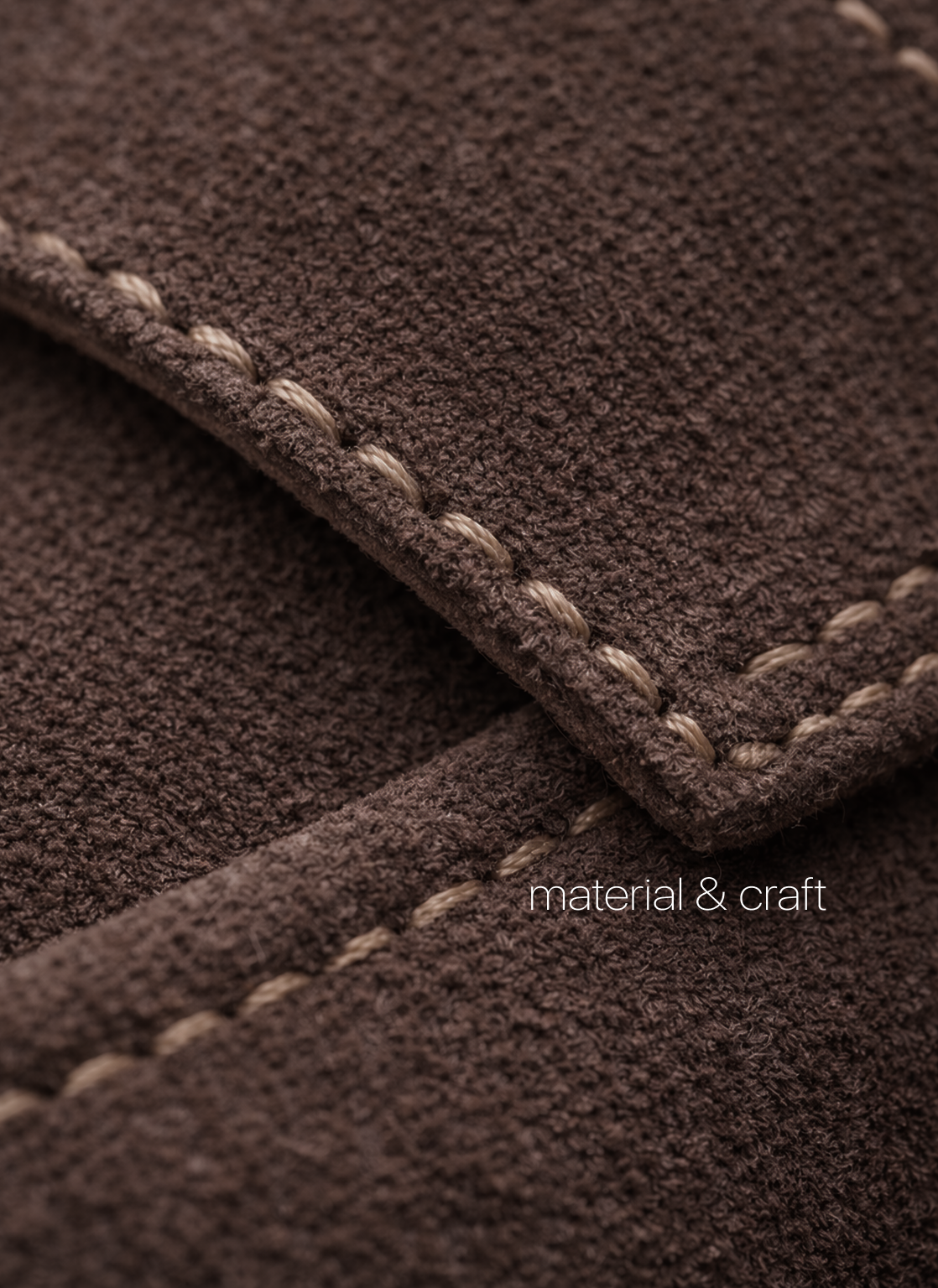 Close-up of suede material and stitching detail used in KMRO mule construction.