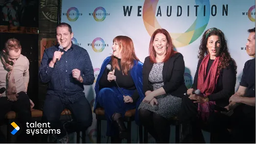 Five people sitting on stools engaged in a lively panel discussion under a 'We Audition' banner, with Talent Systems logo in the corner.
