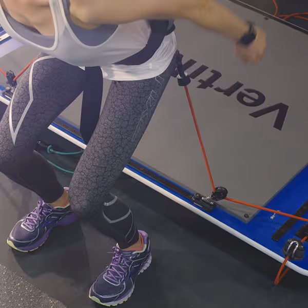 Person exercising with resistance bands attached to a VertiFit exercise platform.