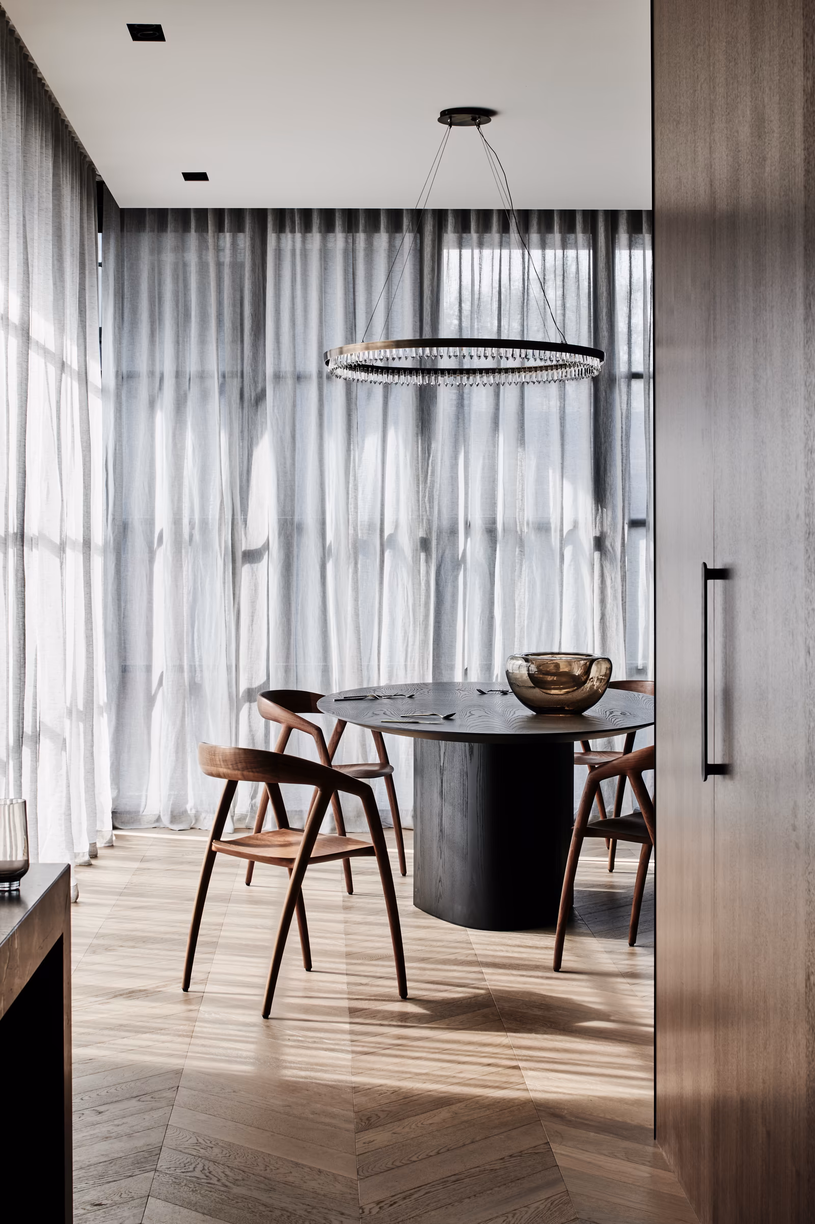 dining area with round dark timber table, timber chairs and crystal ring pendant, opus 73, middle park