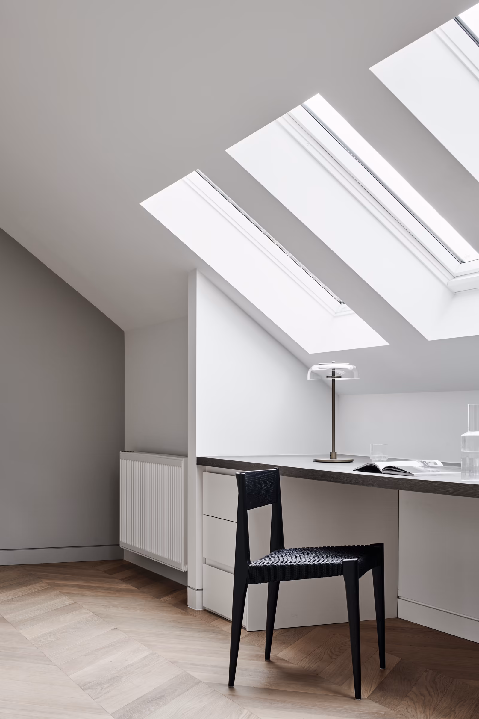 attic study with skylights, built-in desk and black woven-seat chair on chevron timber floor, opus 73, middle park