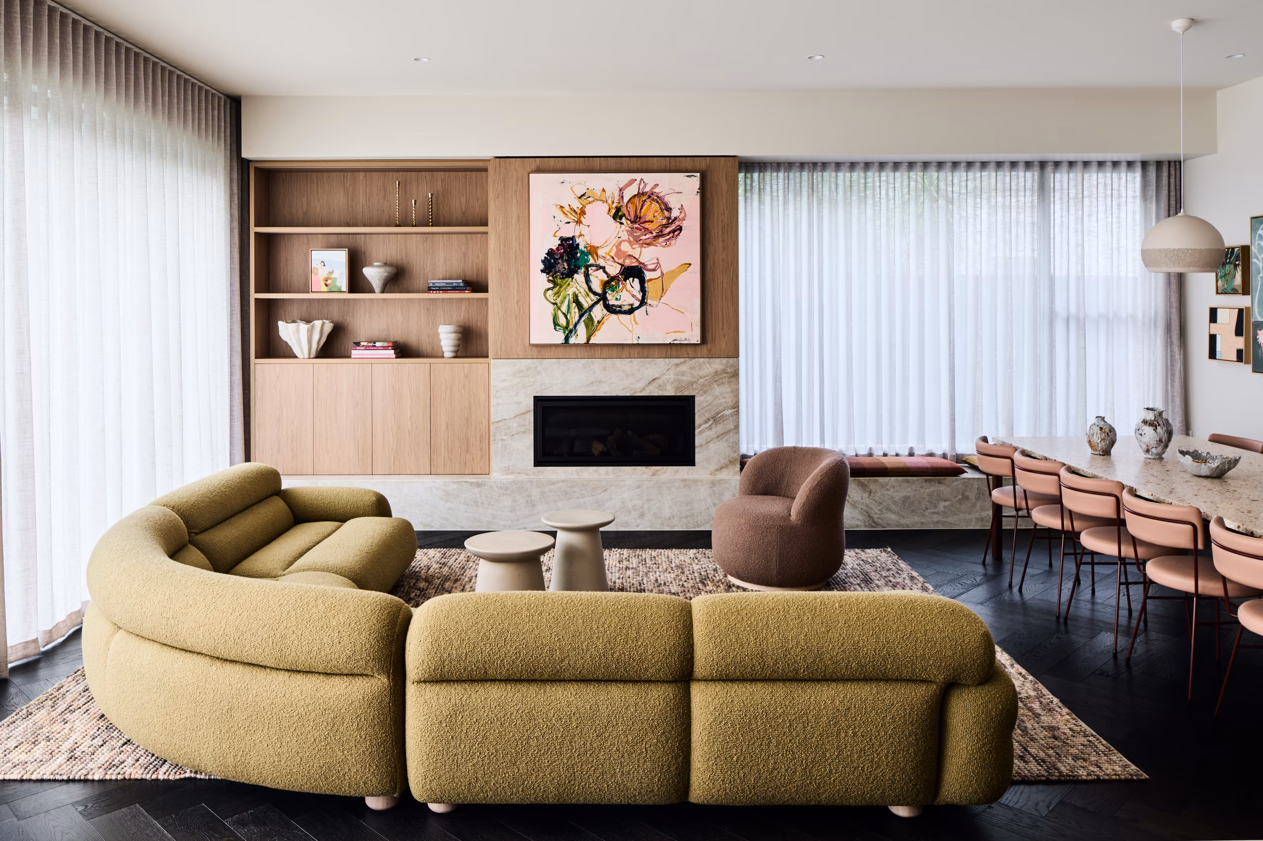 living room with curved olive boucle sofa, timber shelving and stone fireplace, opus 5, caulfield north