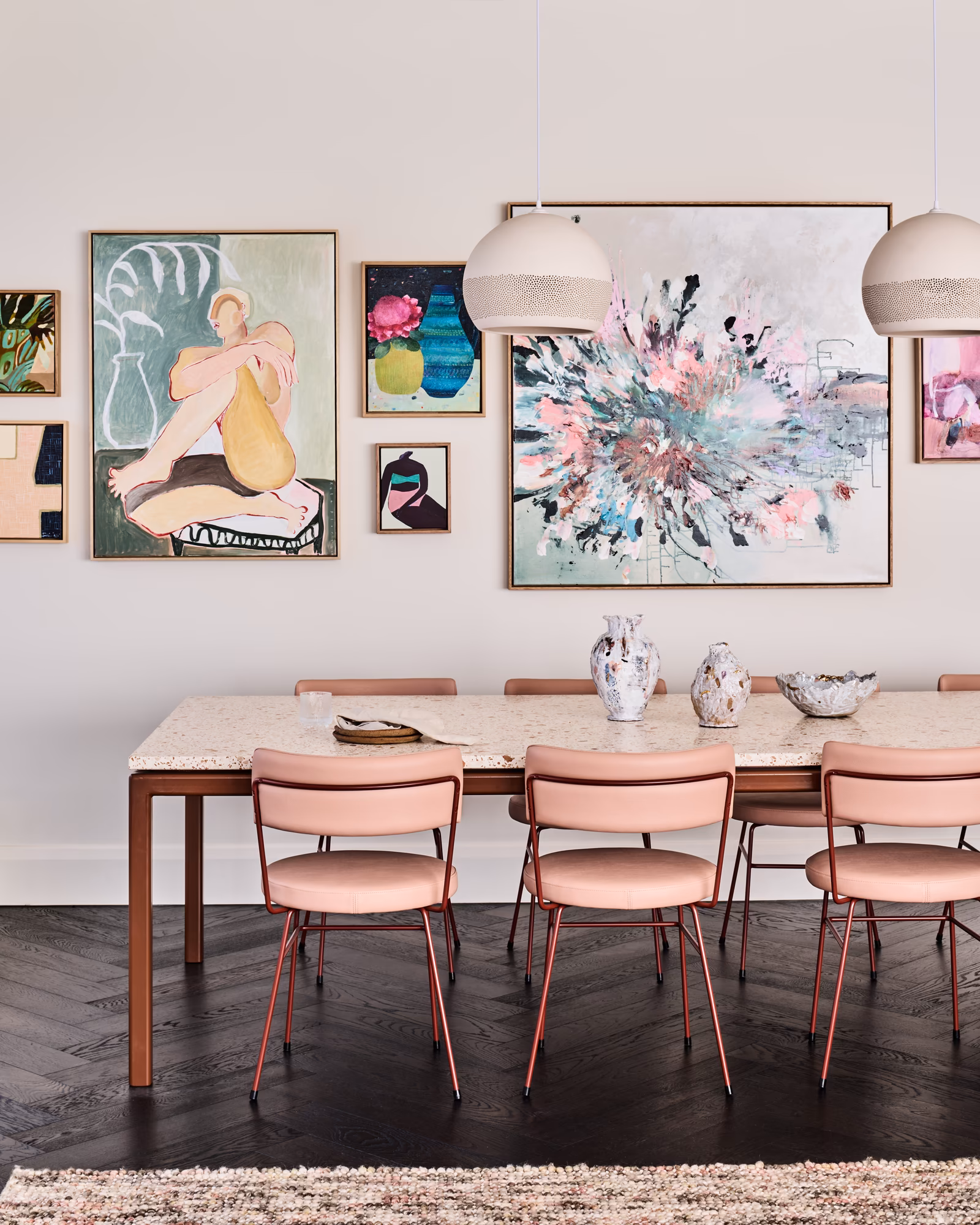 dining table with terrazzo top and pink chairs below a gallery wall and two pendants, opus 5, caulfield north